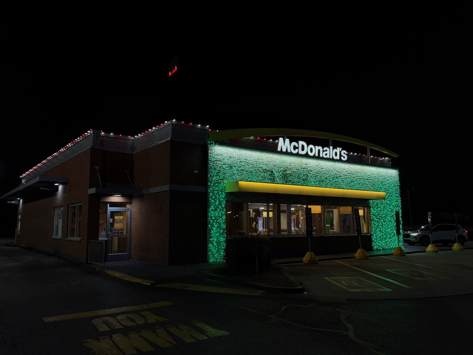 McDonald's restaurant front wrapped in green light curtains with a red and white roofline, Bowling Green KY