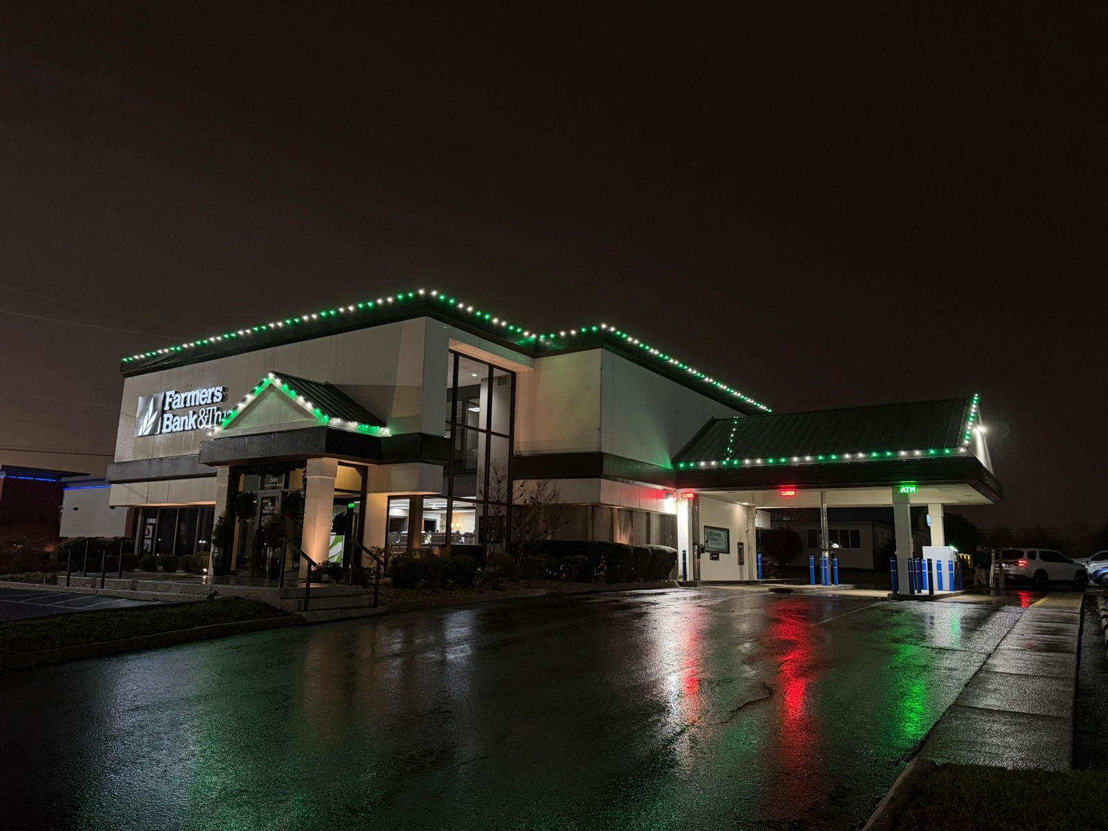 Farmers Bank and Trust building outlined in green and white holiday lighting, Bowling Green KY